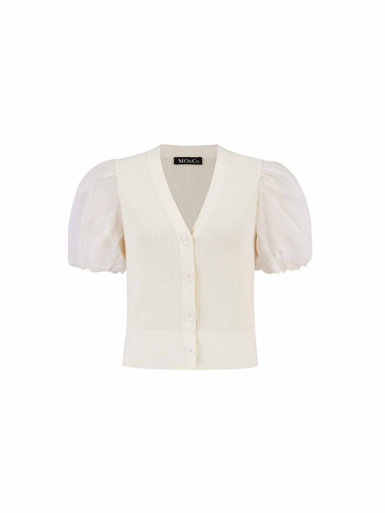 MO&Co. Women's Cotton Blend Crop Knitted Cardigan in Beige. This modern knit top fits slim with V-neck & features puff sleeves & tulle panel details.