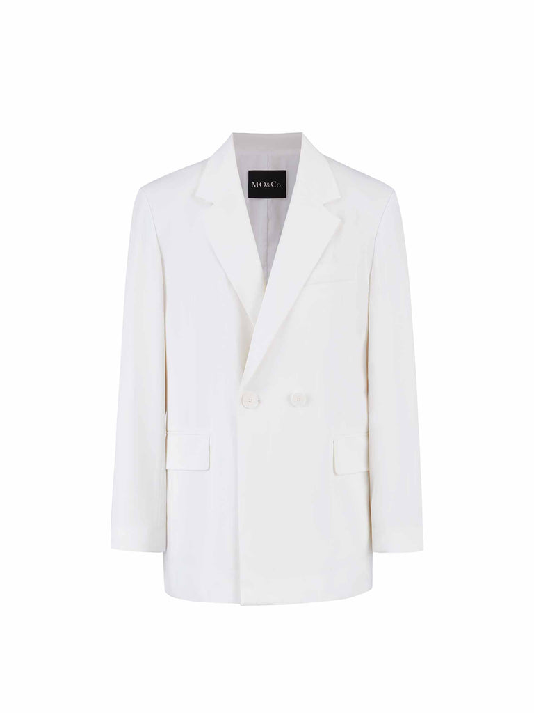 MO&Co. Bowknot Details Structured Blazer in White. Made from comfy, smooth acetate blend materials with intricate bowknot and slit details on the back, this blazer also includes shoulder pads and a button closure.