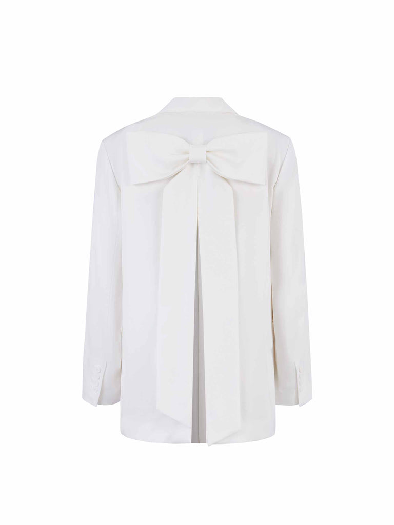 MO&Co. Bowknot Details Structured Blazer in White. Made from comfy, smooth acetate blend materials with intricate bowknot and slit details on the back, this blazer also includes shoulder pads and a button closure.