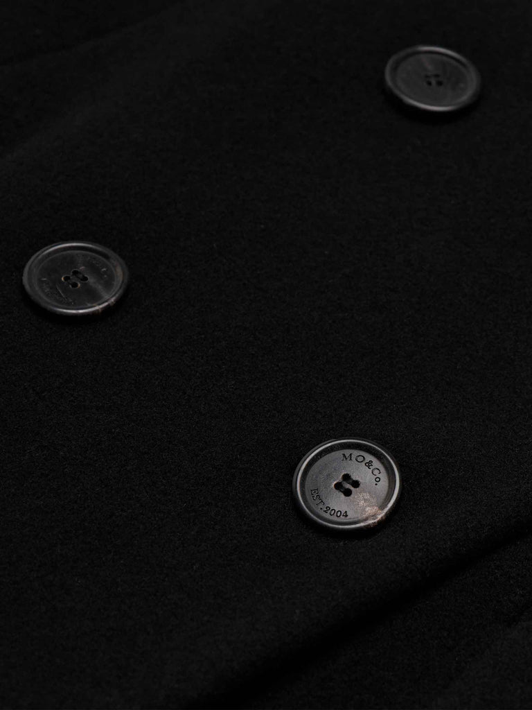 MO&Co. Women's V-neck Quilted Shell Wool Blend Jacket in Black, featuring a button closure and flap pocket design. Wool panel front , quilted shell sleeves and back add a unique touch and extra warmth.