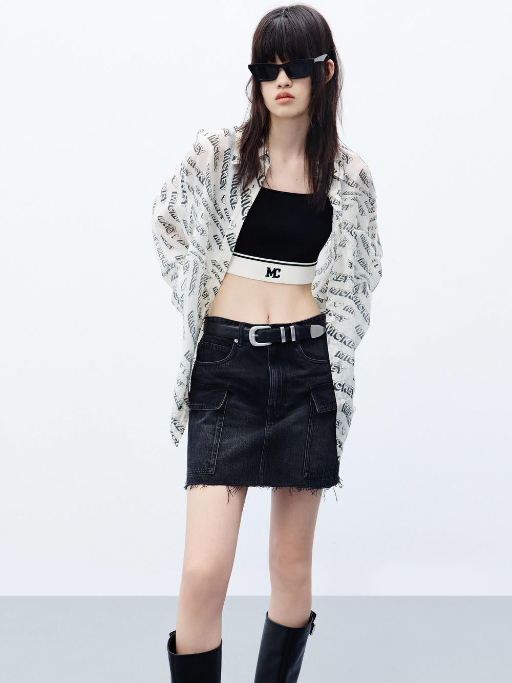 MO&Co. Women's Cropped Tank Top with Stretchy in Black. Featuring a 50.9% viscose blend with a hint of stretch, squared neckline, a chic cropped silhouette & contrast palette with an "MC" logo.