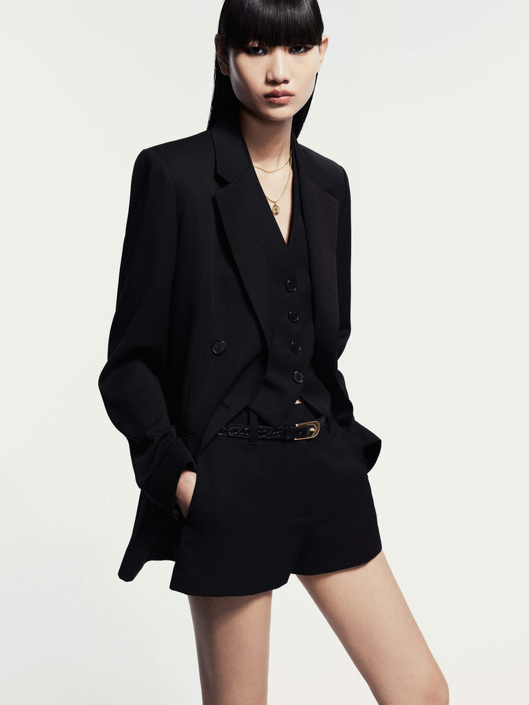 MO&Co. Noir Women's Peak Lapel Wool Blazer in Black crafted from comfortable Merino wool, this blazer features a classic double-breasted design with padded shoulders for a structured look.