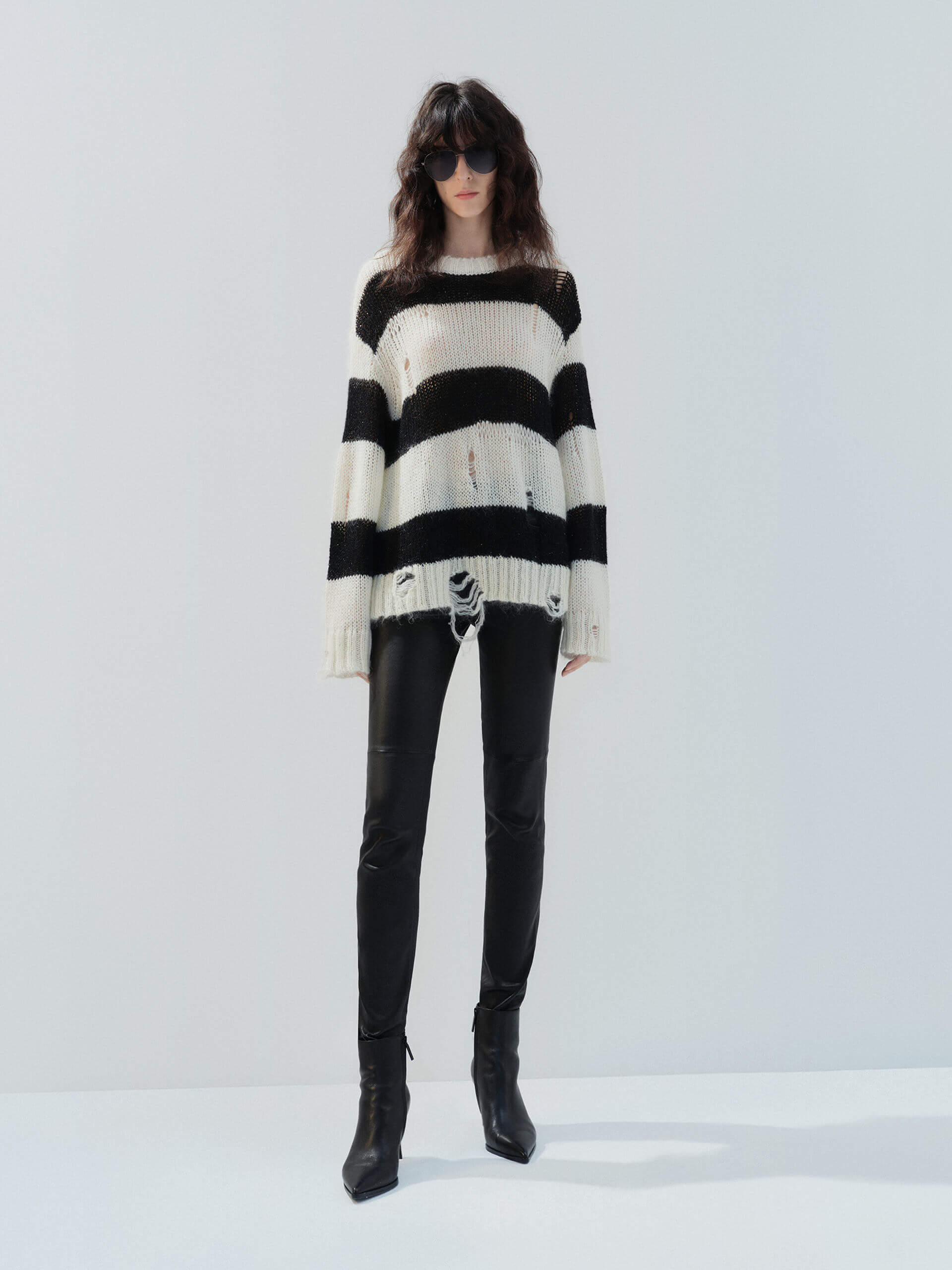 MO&Co. Noir Women's Distressed Detail Striped Oversized Pullover Crafted from a blend of mohair and wool, this sweater offers a fuzzy texture and distressed design for a modern twist.