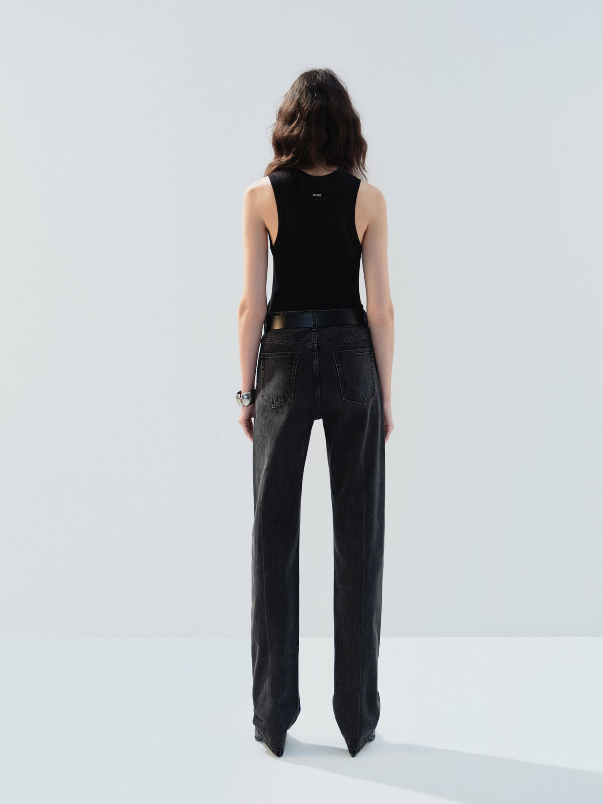 MO&Co. Noir Women's Black Ribbed Tank Top in Black | Versatile and Stylish crafted from a soft organic cotton-blend jersey with a slim stretchy ribbed tight fit.