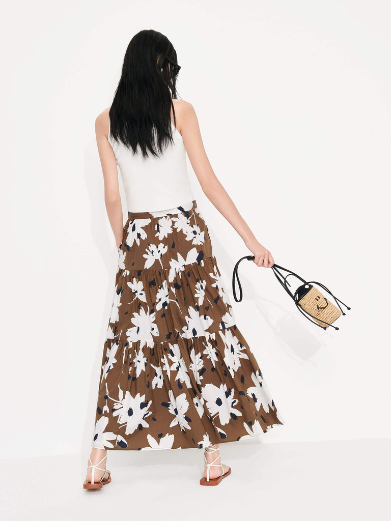 MO&Co. Women's Tiered Floral Print Maxi Skirt in Brown features a flowy fit, high waist and pleated design. Plus, the bold floral print and side zipper closure create a standout style.
