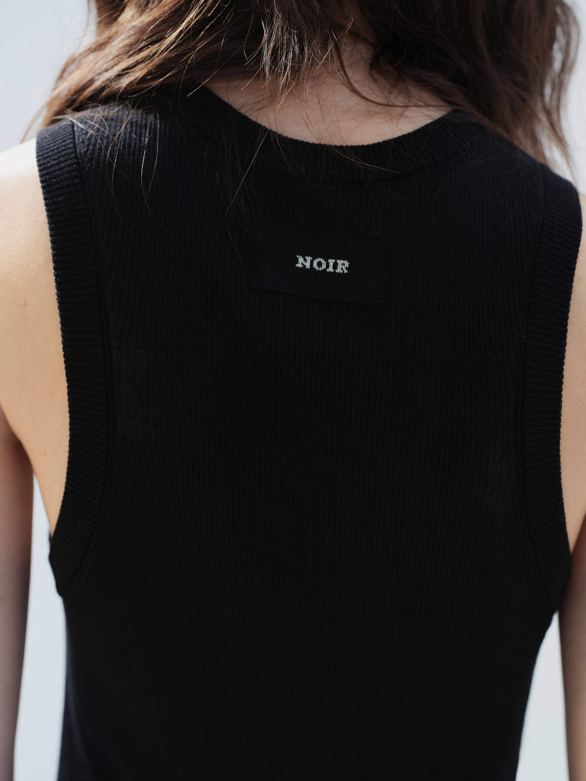 MO&Co. Noir Women's Black Ribbed Tank Top in Black | Versatile and Stylish crafted from a soft organic cotton-blend jersey with a slim stretchy ribbed tight fit.