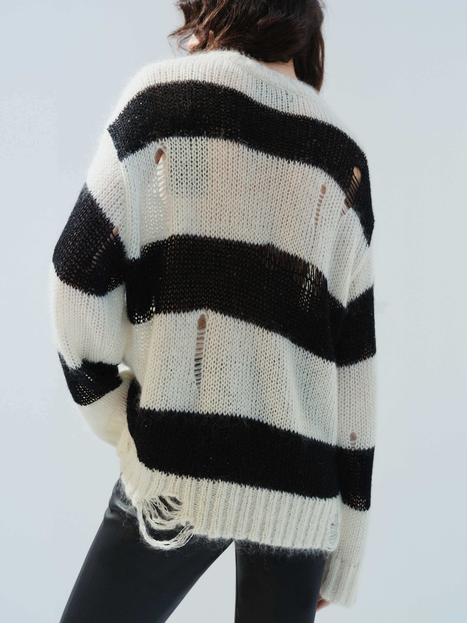 MO&Co. Noir Women's Distressed Detail Striped Oversized Pullover Crafted from a blend of mohair and wool, this sweater offers a fuzzy texture and distressed design for a modern twist.