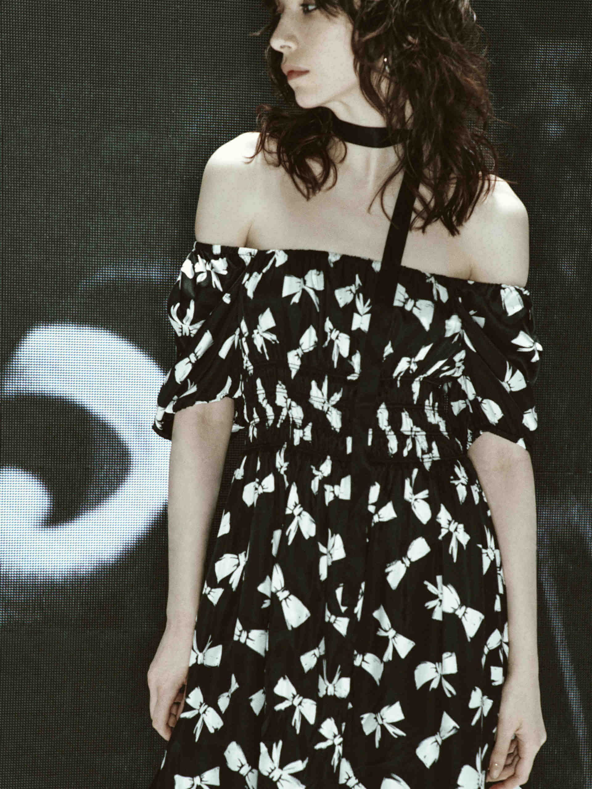 MO&Co. Women's Bowknot Pattern Flowy Mini Dress in Black. Crafted from luxurious silk and viscose blend fabric with an all-over bowknot print, self-tie details at back and square neckline, and elasticized shoulders for a smocked waist design.