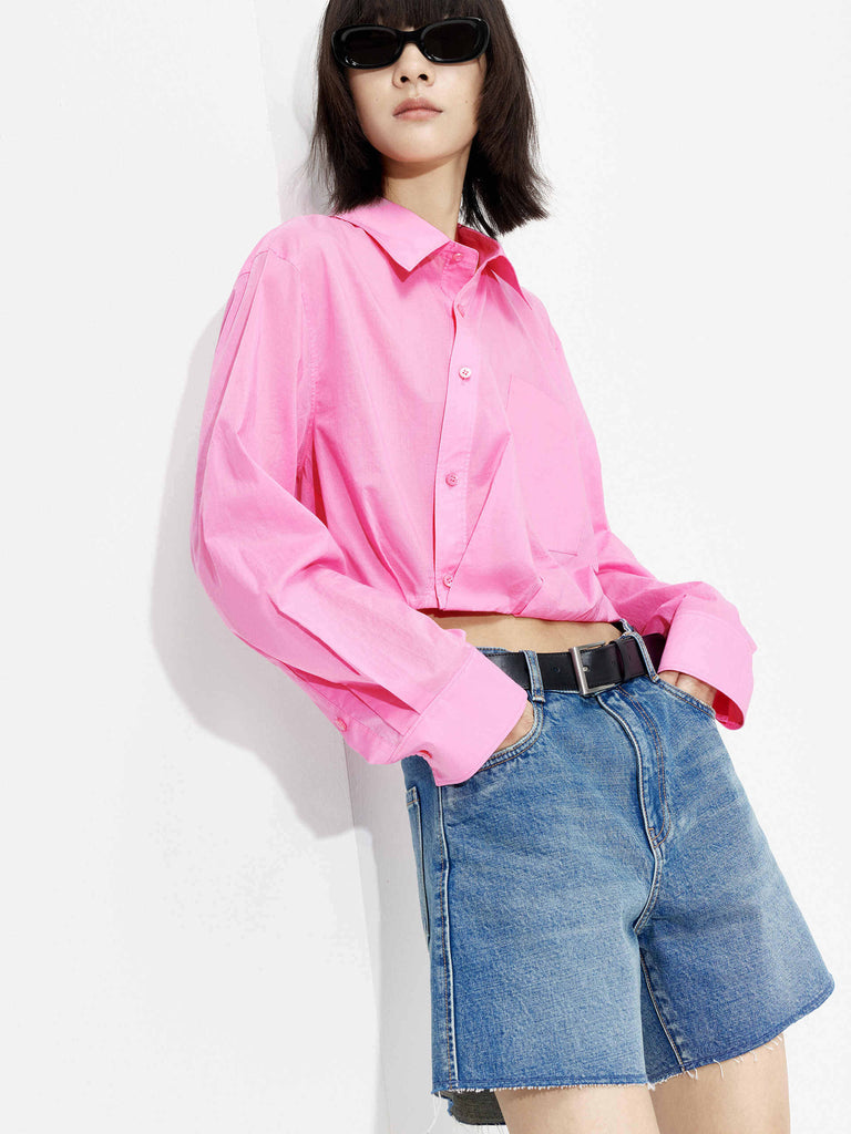 MO&Co. Women's Slanted Placket Cropped Shirt in Pink. Crafted with a stylish cropped silhouette and slanted placket design, this fashion-forward piece is bound to turn heads. Plus, it's complete with a front pocket and elastic hem for a unique look.