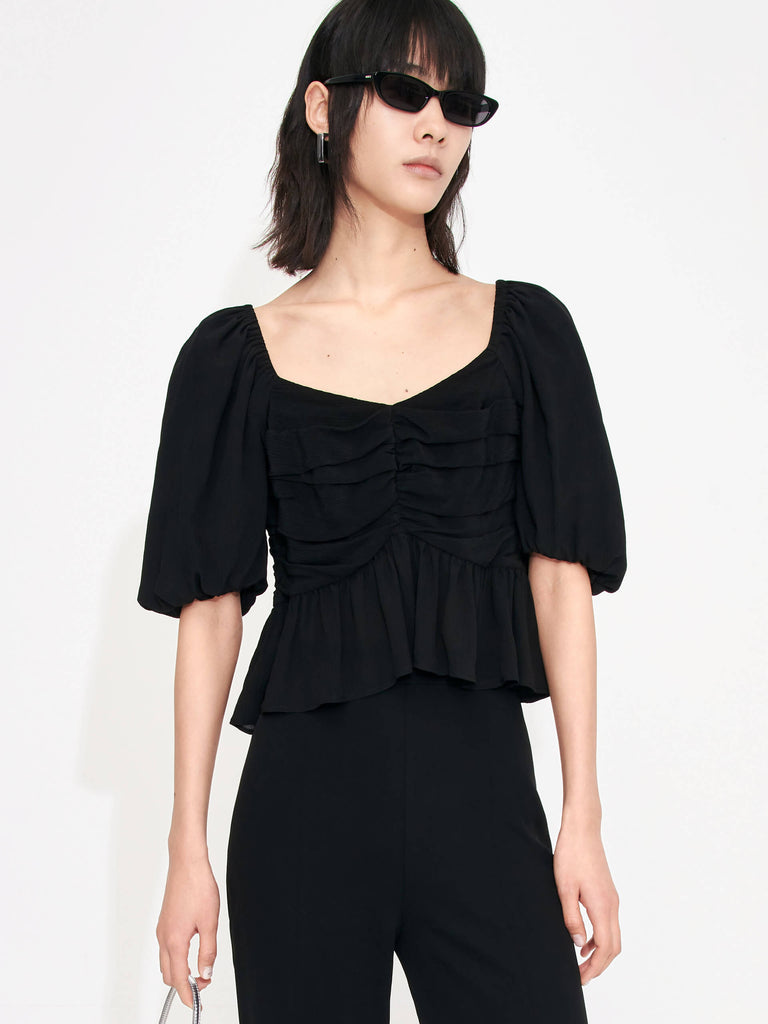 Bring a touch of luxury to your wardrobe with this MO&Co. Women's Pleated Detail Silk Top. Crafted from soft and lightweight silk material, it features a heart-shape neckline and puff sleeves with pleated details and a ruffled hem. The back of the top boasts an eye-catching tie-strap detail,