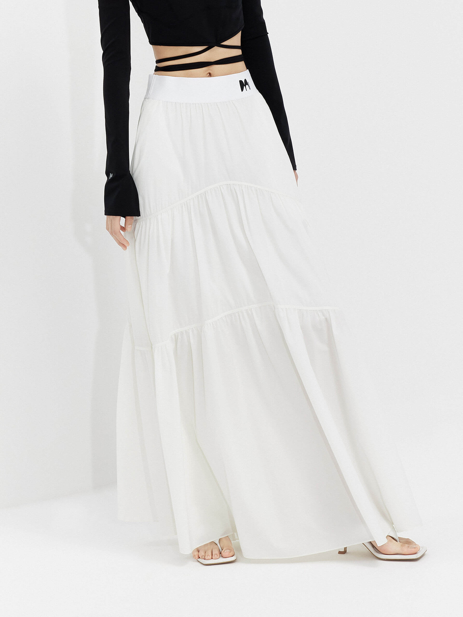 MO&Co. Women's Flowy Prairie Maxi Skirt in White for Summer Day features double side pockets, cool-touch fabric, an elasticized waistband, and gathered seam details for a perfect fit.