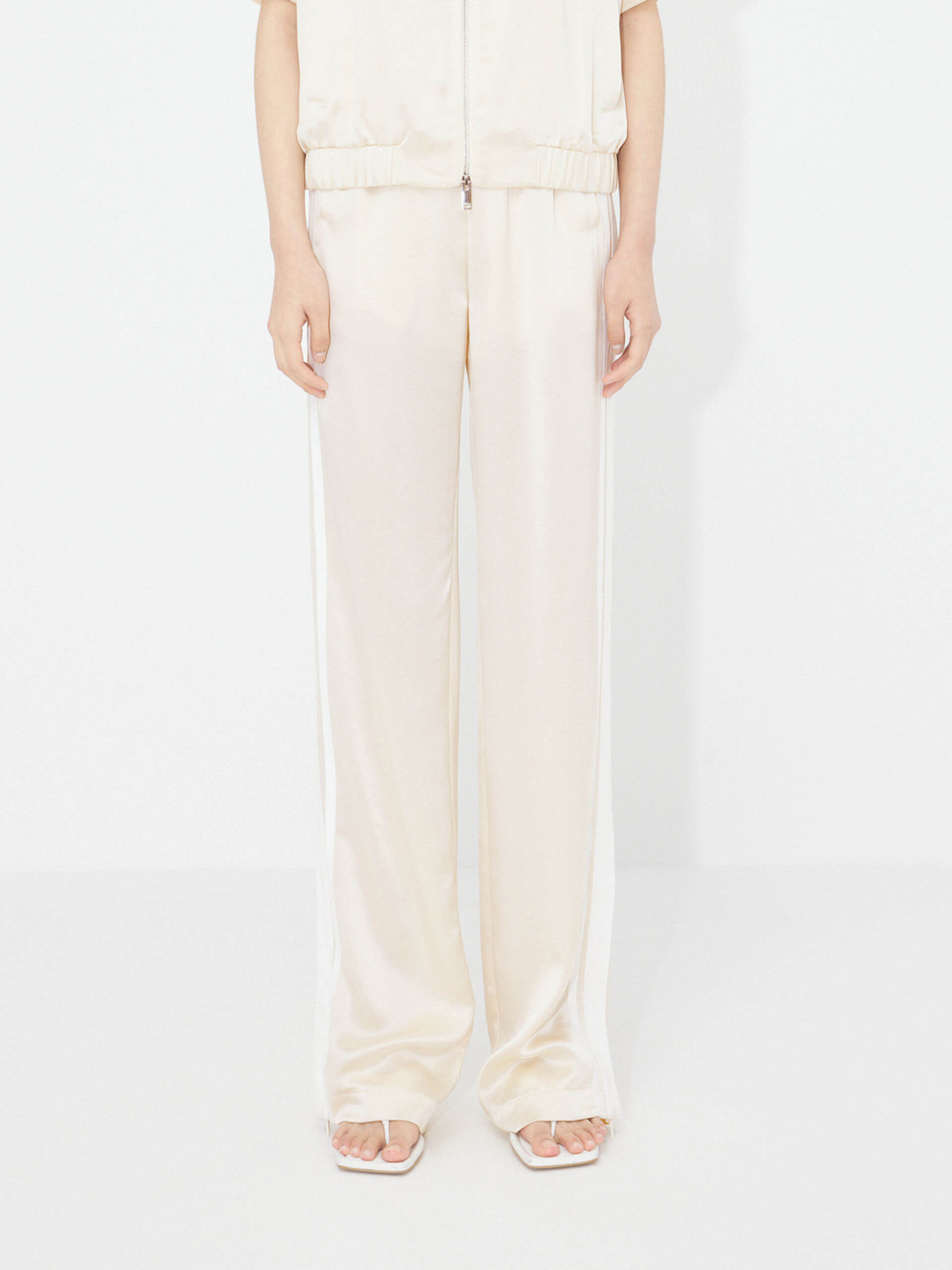 MO&Co. Women's Contrast Elastic Waist Pants in Beige feature a straight leg, contrast trim design, and an elasticated waistband with side pockets. An acetate blend fabric ensures these pants are incredibly soft, smooth, and comfortable.