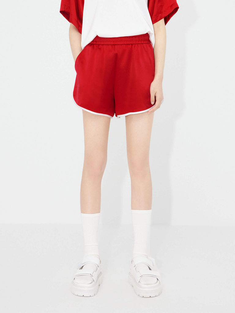 MO&Co. Women's Acetate Blend Contrast Track Shorts in Red feature a stylish athleisure silhouette, contrasting trim design, an elasticized waistband, and slant pockets--all constructed from a soft, smooth, and comfy acetate blend fabric.