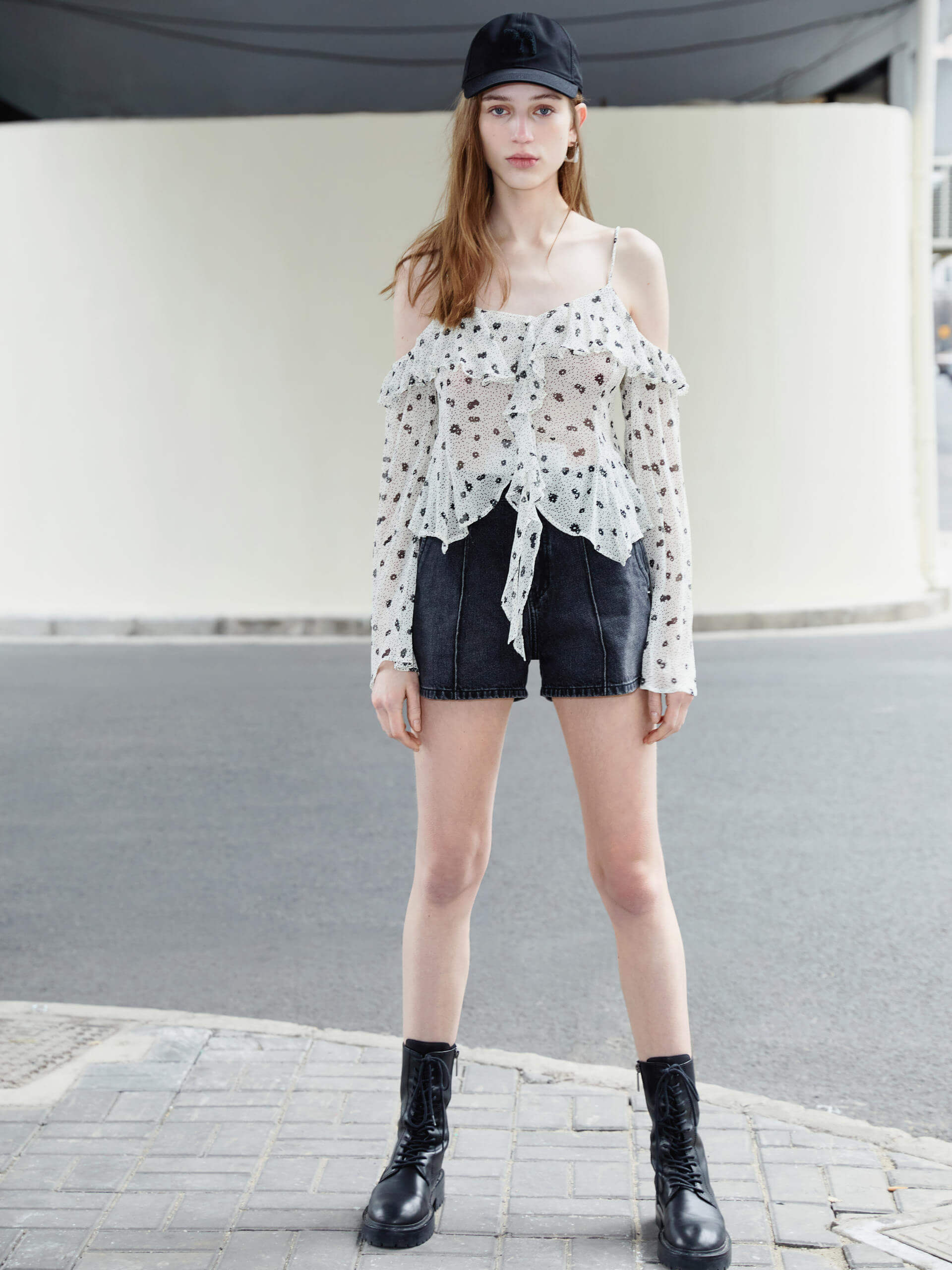 This MO&Co. Cut Shoulder Printed Top in White is crafted from 100% recyclable fibers, making it a stylish and sustainable choice. Show off your fashion-forward style with off-shoulder trumpet sleeves, a floral and polka dot print, and pleated trim detailing on the front. Elevate your wardrobe with this statement piece!