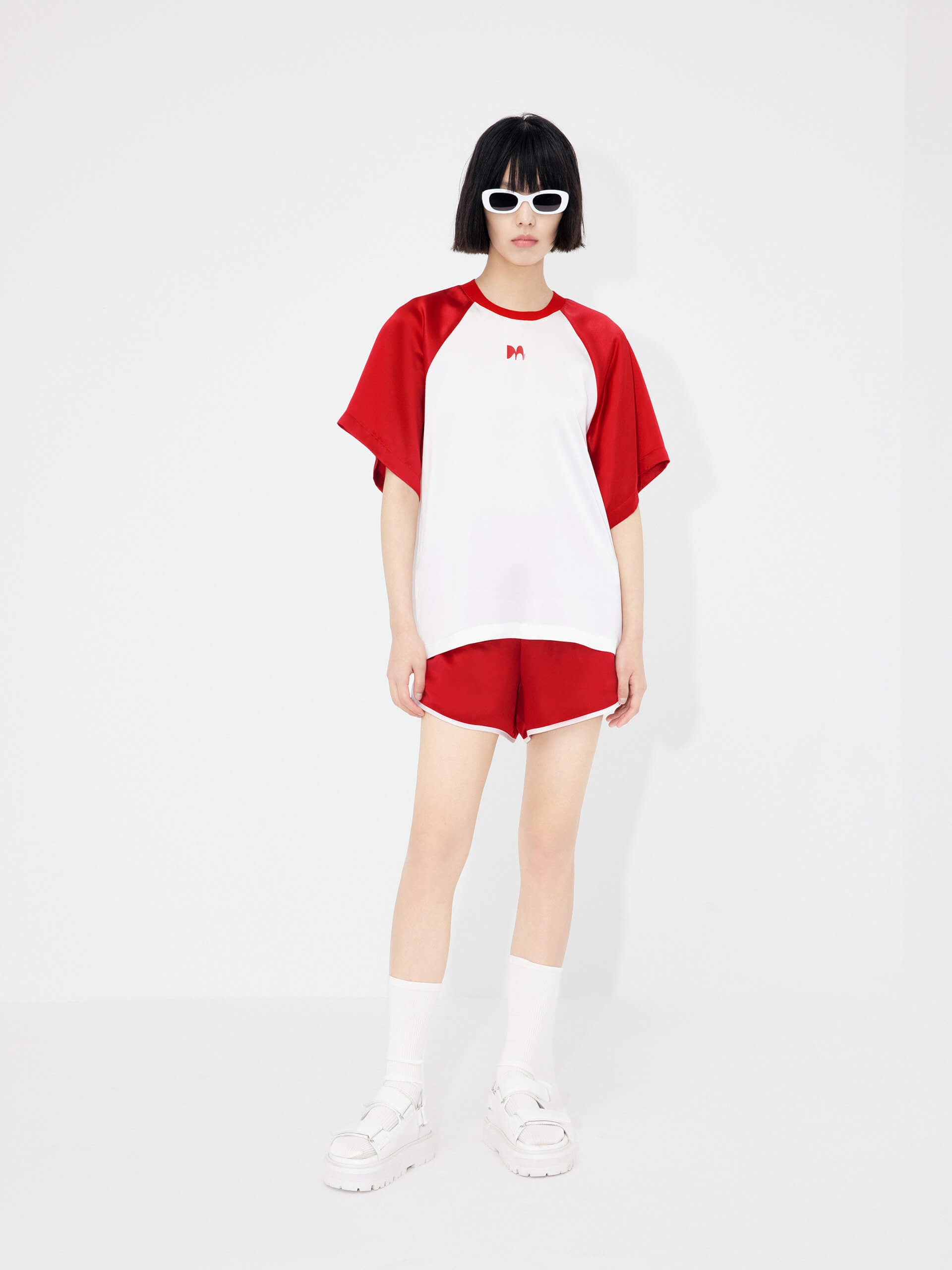 MO&Co. Women's Acetate Blend Contrast Track Shorts in Red feature a stylish athleisure silhouette, contrasting trim design, an elasticized waistband, and slant pockets--all constructed from a soft, smooth, and comfy acetate blend fabric.