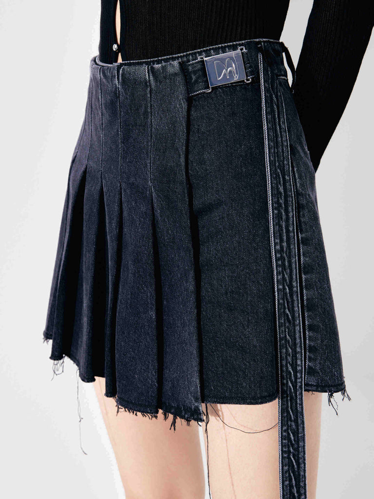 MO&Co.'s Women's Wrap Detail Pleated Black denim Shorts. Features include mini length, raw hem details and a wrap pleated patch with buckle belt.