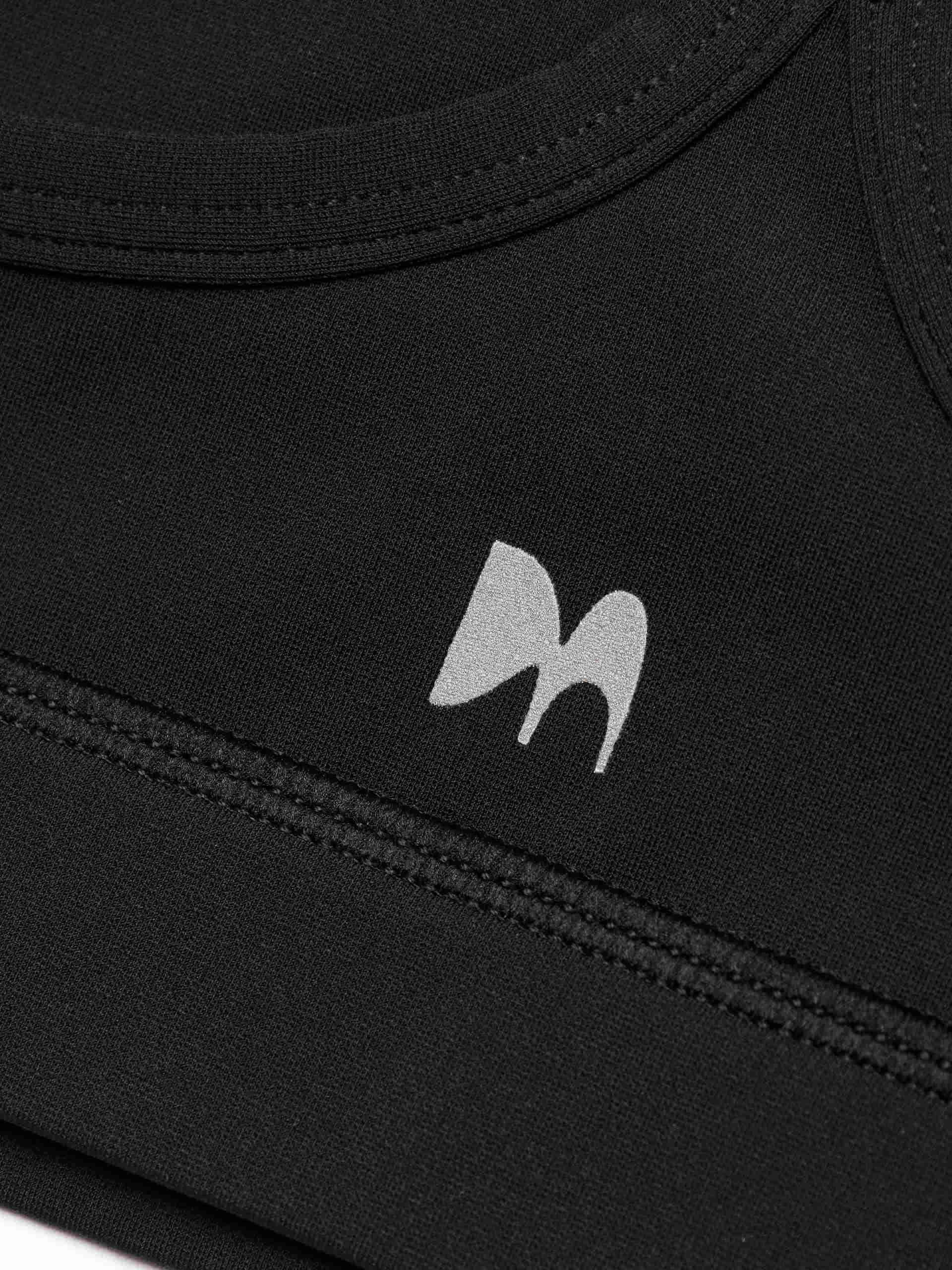 MO&Co. Women's Cropped Sports Bra in Black offers versatile style ideal for any activity. Its scoop neck, racerback, and elasticized hem provide ultimate comfort. Plus, it features UPF 40+ sun protection. Crafted with cool touch fabric and equipped with non-adjustable thin straps and removable cups.