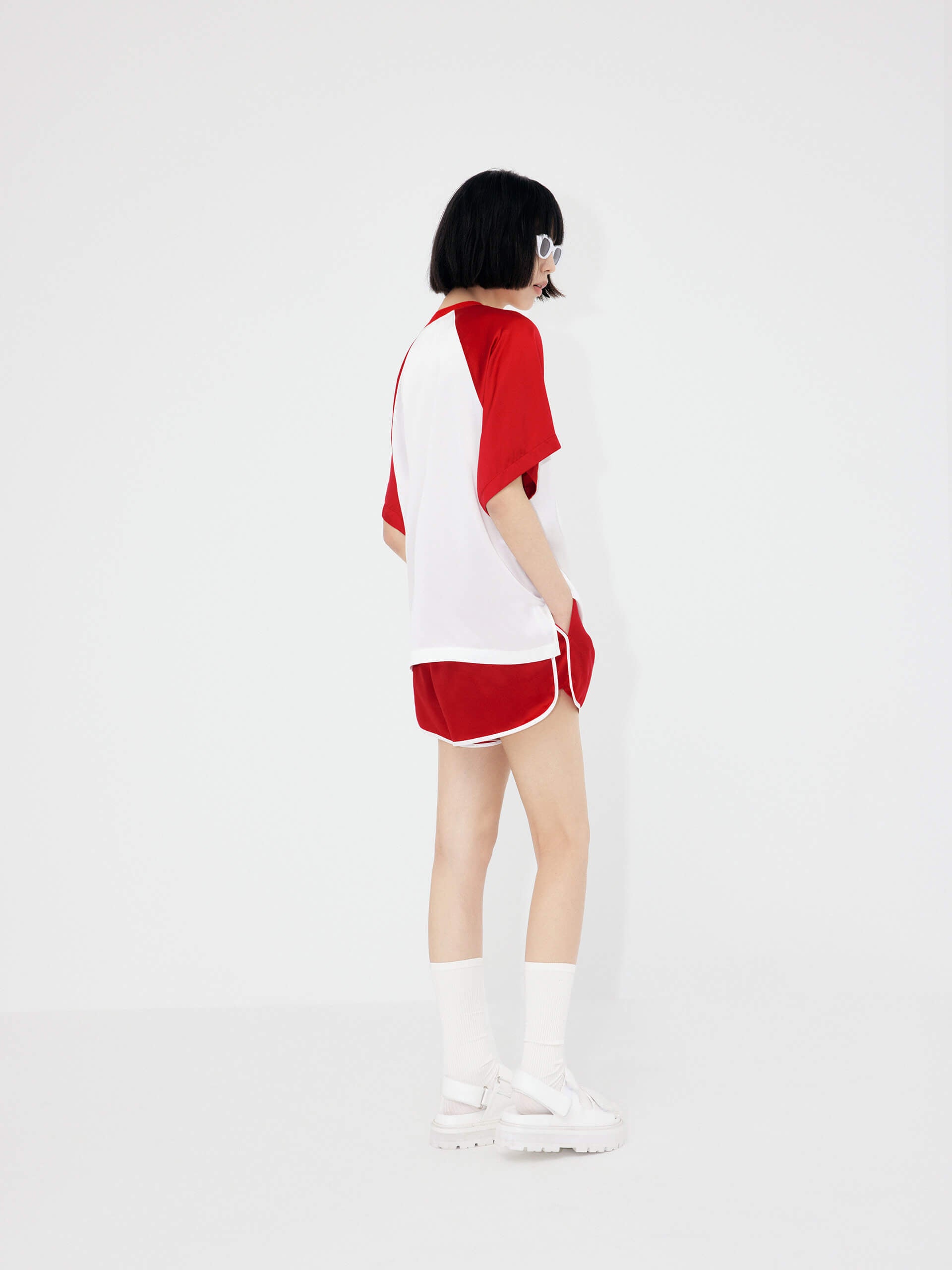 MO&Co. Women's Acetate Blend Contrast Track Shorts in Red feature a stylish athleisure silhouette, contrasting trim design, an elasticized waistband, and slant pockets--all constructed from a soft, smooth, and comfy acetate blend fabric.