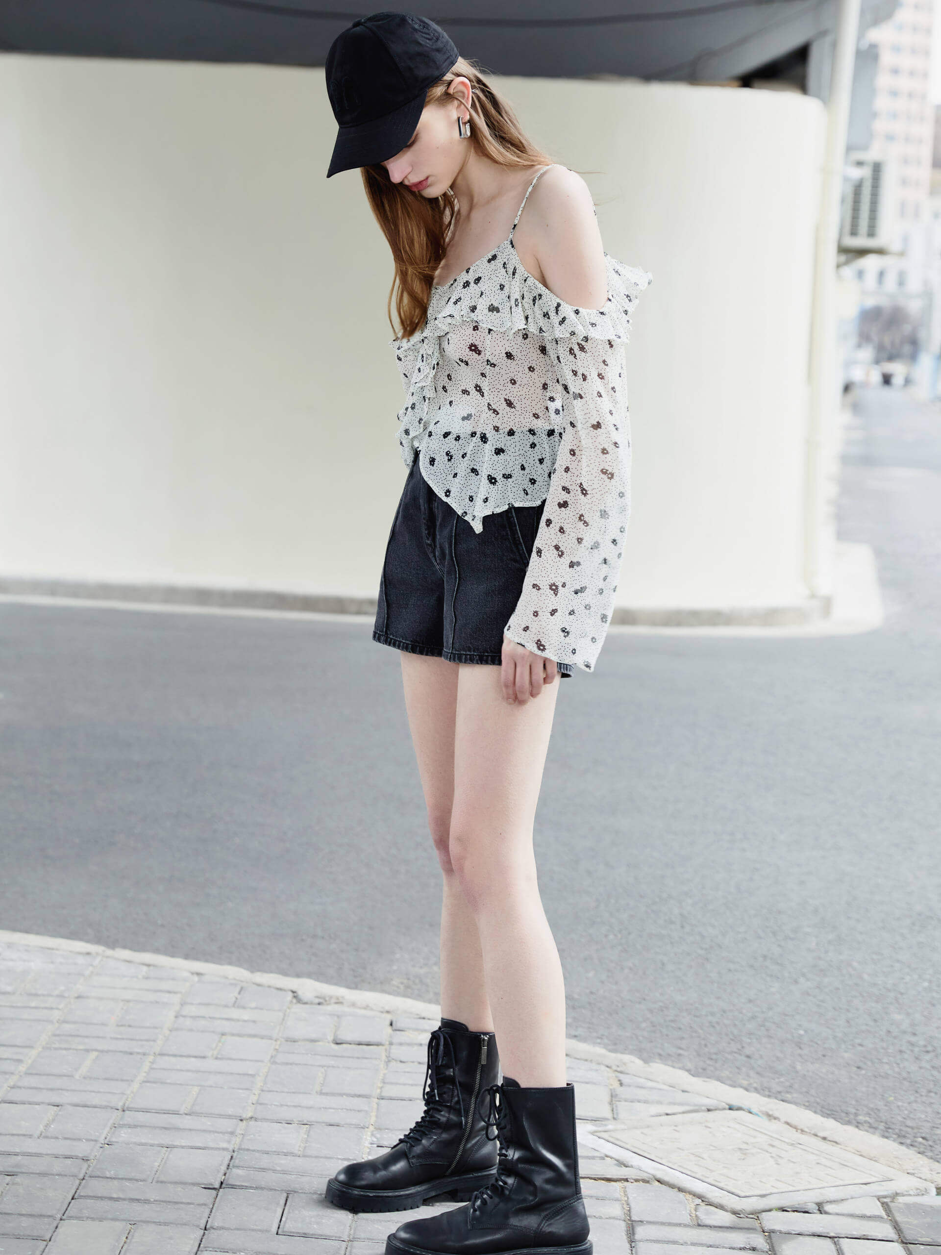 This MO&Co. Cut Shoulder Printed Top in White is crafted from 100% recyclable fibers, making it a stylish and sustainable choice. Show off your fashion-forward style with off-shoulder trumpet sleeves, a floral and polka dot print, and pleated trim detailing on the front. Elevate your wardrobe with this statement piece!