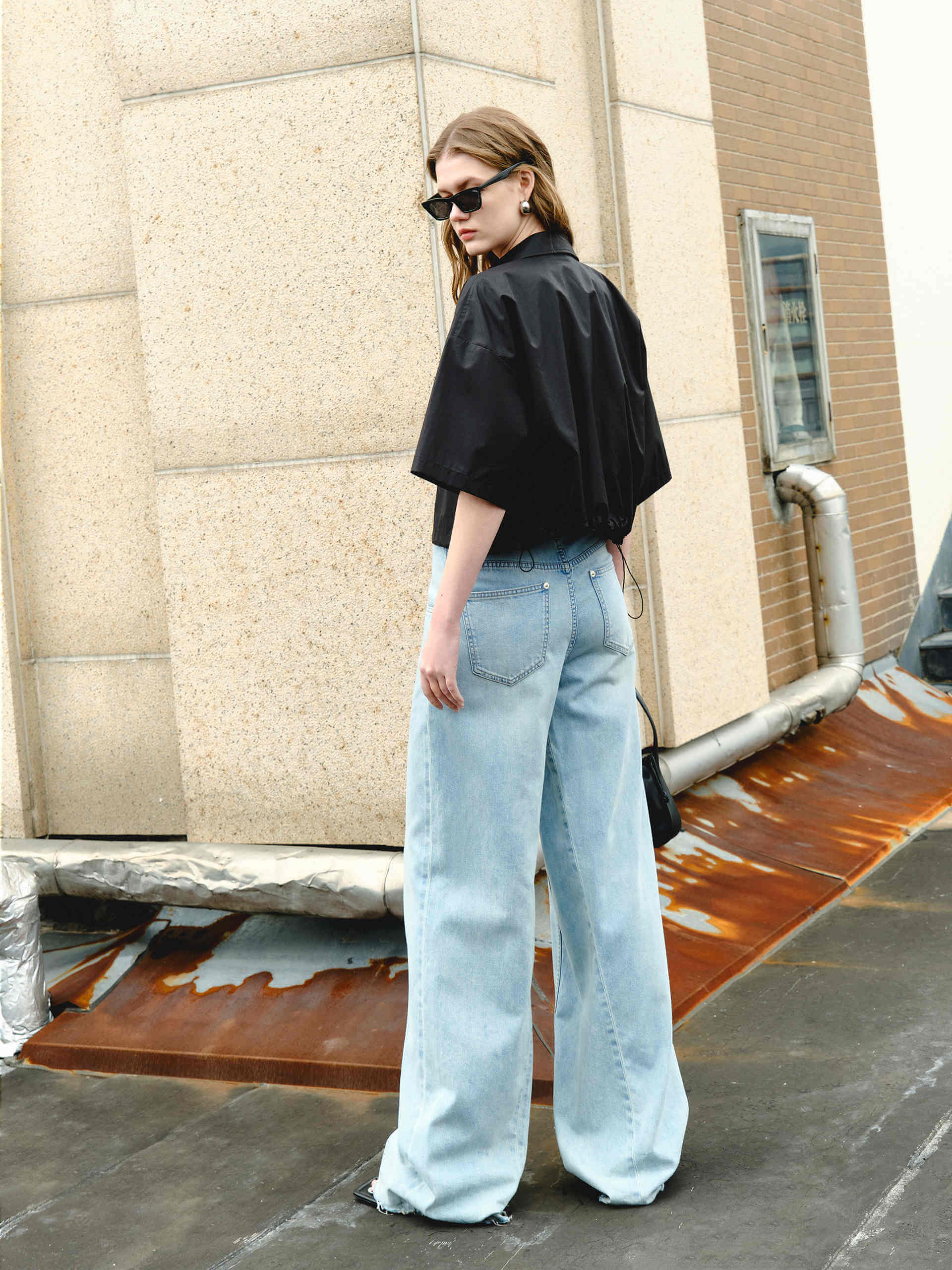 MO&Co. Women's Boxy Fit Cotton Shirt Jacket in Short Sleeves in black features cropped, short sleeves, a button closure, and a M metallic embellishment at the front. Choose from color in purple and black, and pair with the matching shorts for a stylish look.