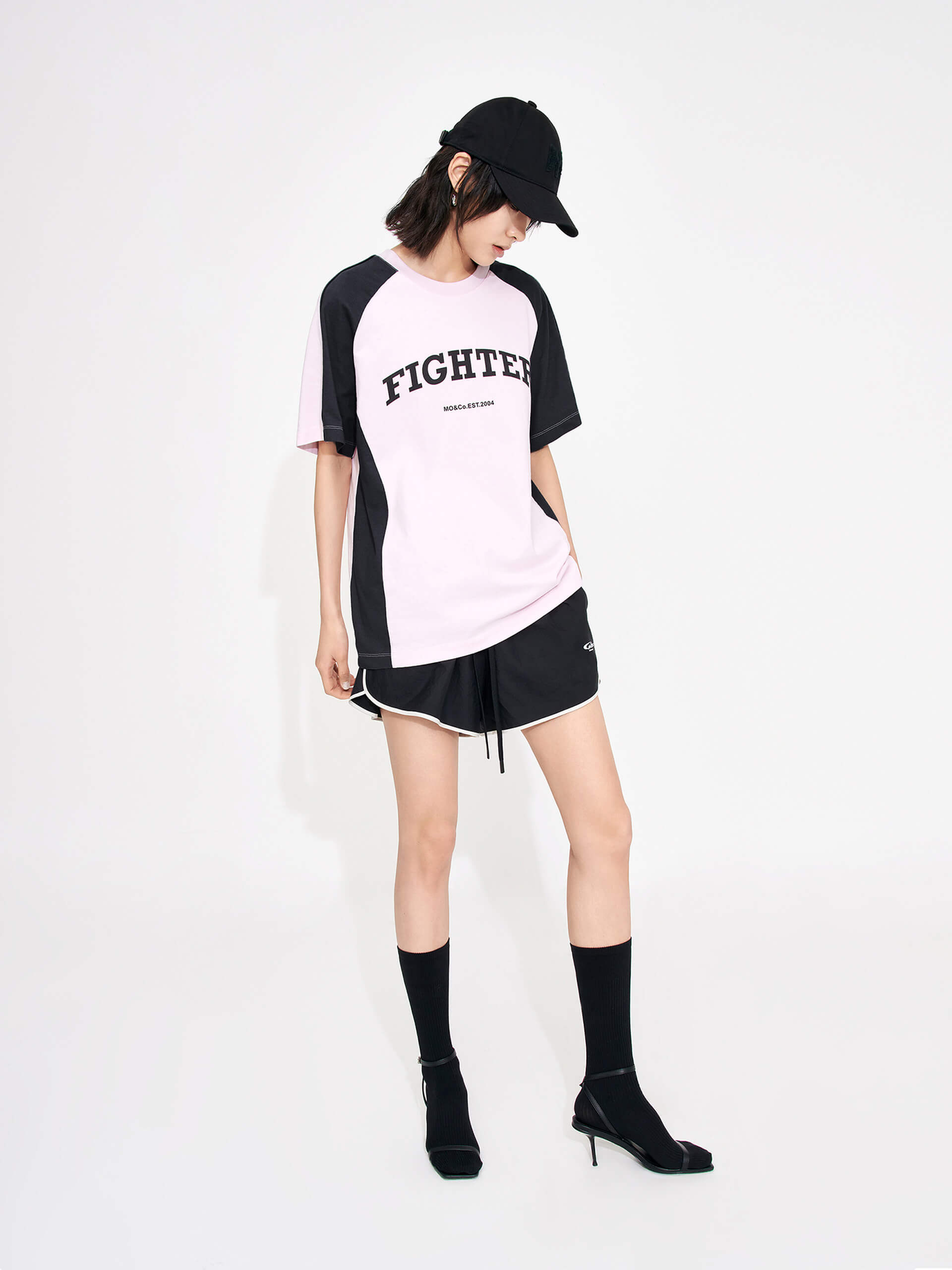 MO&Co. Women's Color Block Letter Print Relaxed Fit Cotton T-shirt in Pink featuring raglan sleeves with color block details, a letter print on the chest, the relaxed fit and crew neckline give you maximum comfort wherever you go.