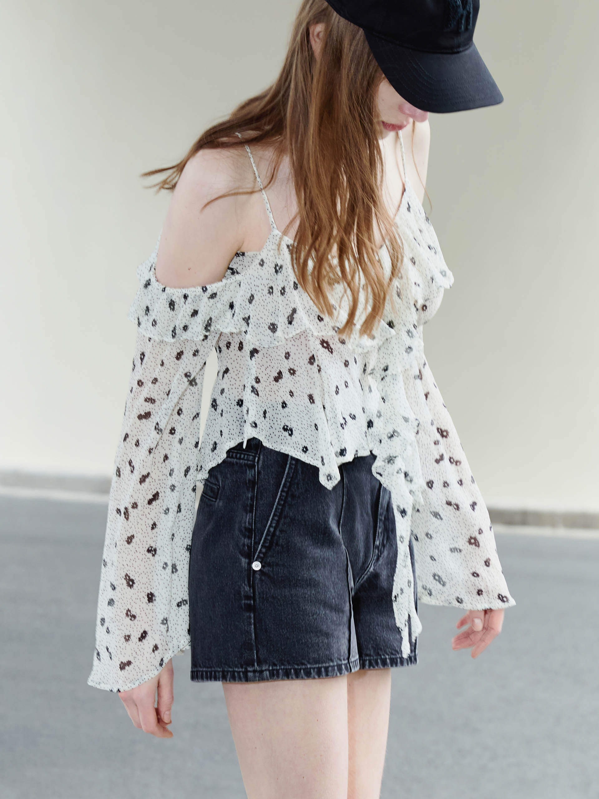 This MO&Co. Cut Shoulder Printed Top in White is crafted from 100% recyclable fibers, making it a stylish and sustainable choice. Show off your fashion-forward style with off-shoulder trumpet sleeves, a floral and polka dot print, and pleated trim detailing on the front. Elevate your wardrobe with this statement piece!