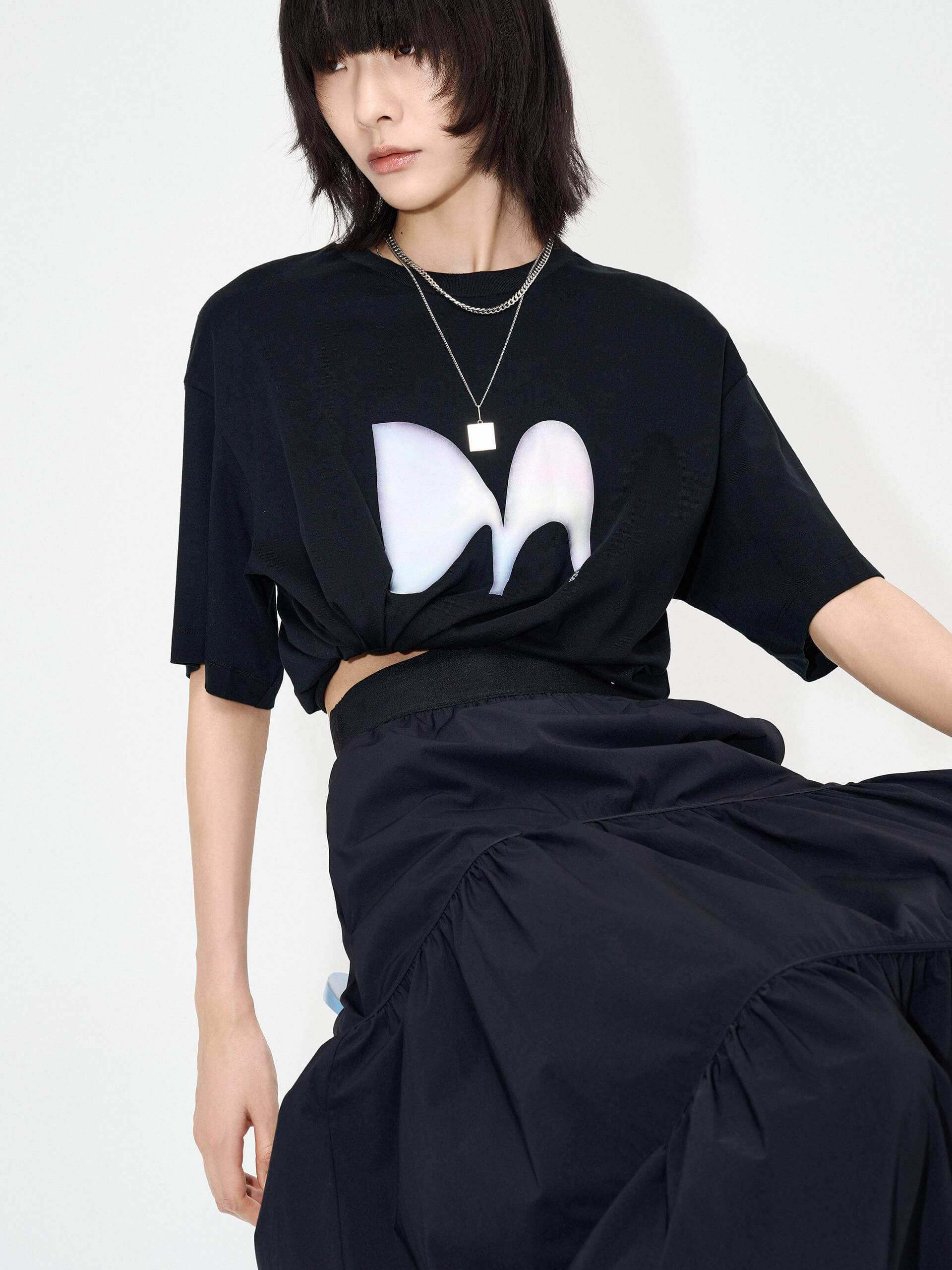 MO&Co. Women's Flowy Prairie Maxi Skirt in Black for Summer Day features double side pockets, cool-touch fabric, an elasticized waistband, and gathered seam details for a perfect fit.