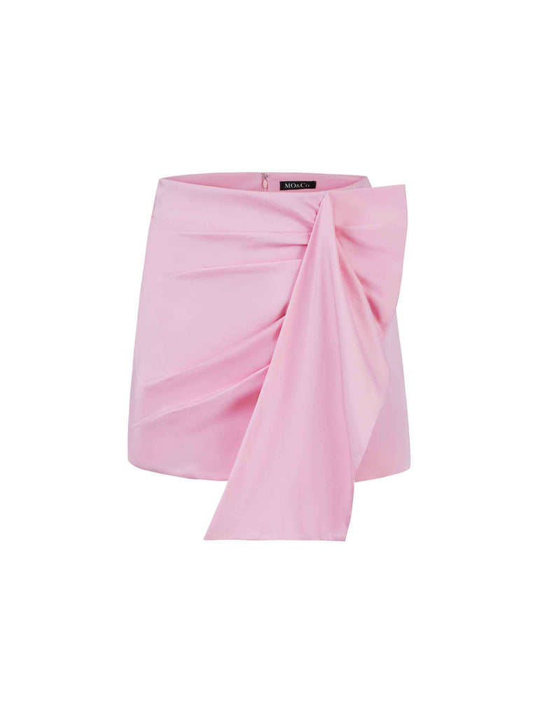 MO&Co. Women's Deconstructed Pleated Skirt in pink. It features flattering pleats and draped front, inner shorts and a-line silhouette.