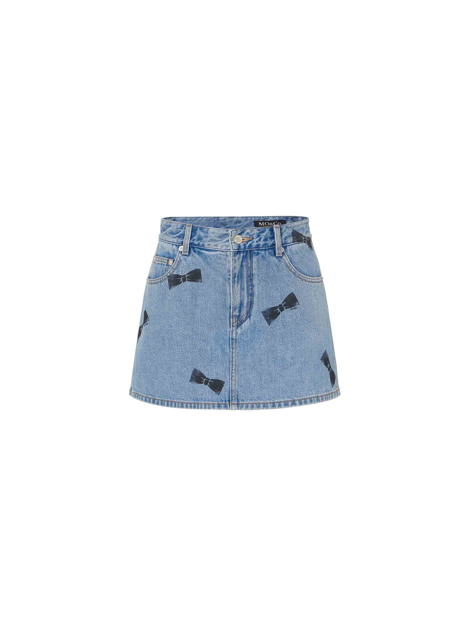 MO&Co. Women's Bowknot Pattern Blue Denim Mini Skort and Short features allover bowknot printed design, mini length, skort silhouette, and a button and zip closure for a perfect fit.