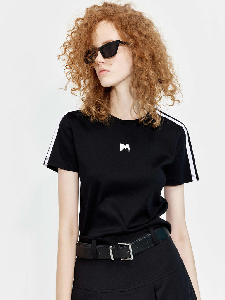 MO&Co.'s cropped logo print T-shirt in Black for women. It offers a slim fit, crewneck, short sleeves, and an M pattern print at the chest. Plus, it features contrasting trim details.