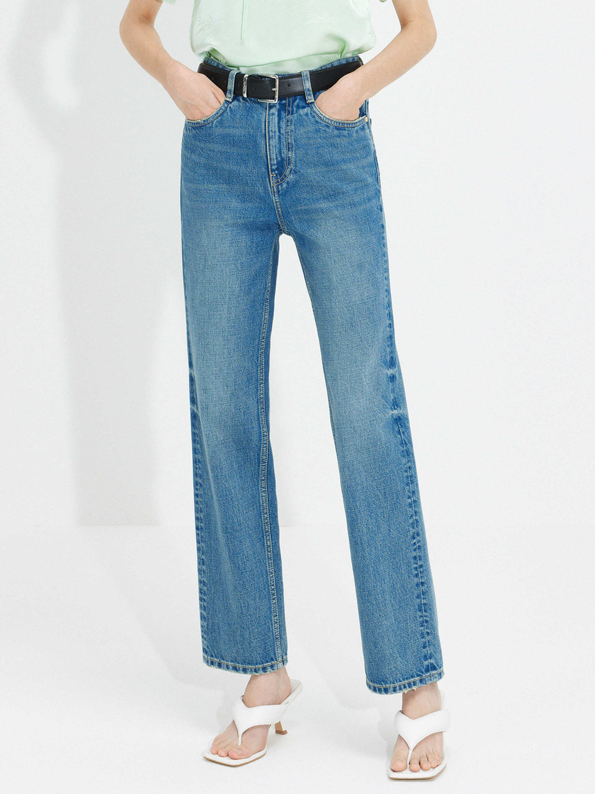 MO&Co. Women's Mid Waist Straight Whiskered Jeans in Blue features a secure button and zip closure, roomy five-pocket design, and easy accessorizing via the belt loops.