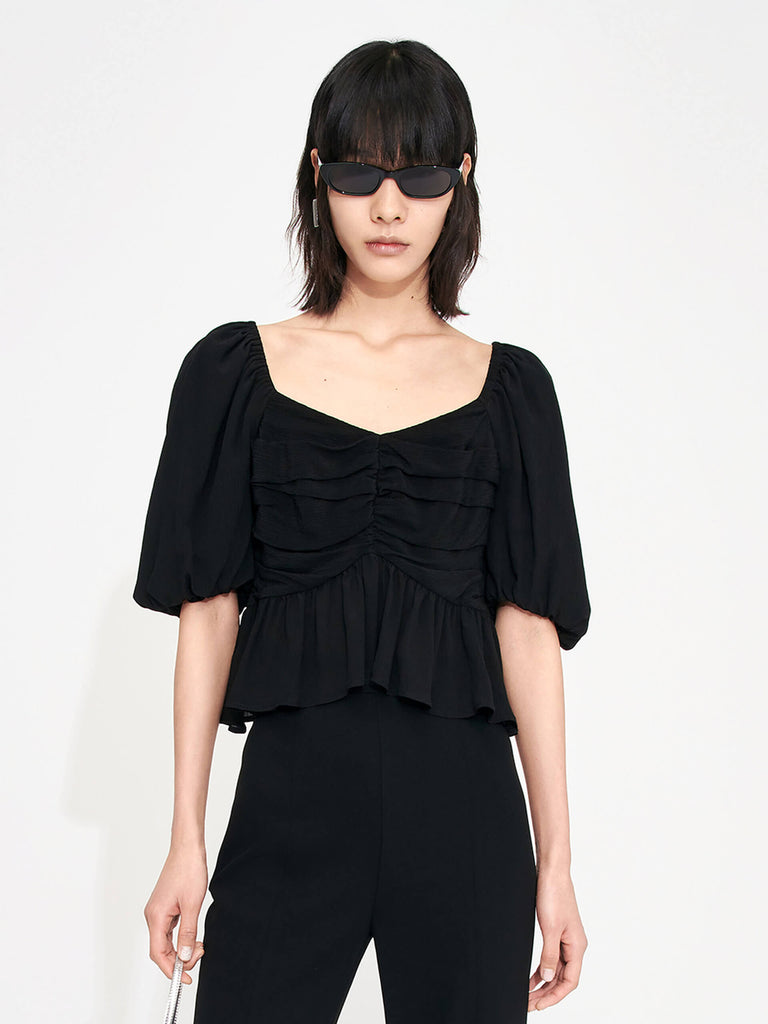 Bring a touch of luxury to your wardrobe with this MO&Co. Women's Pleated Detail Silk Top. Crafted from soft and lightweight silk material, it features a heart-shape neckline and puff sleeves with pleated details and a ruffled hem. The back of the top boasts an eye-catching tie-strap detail,