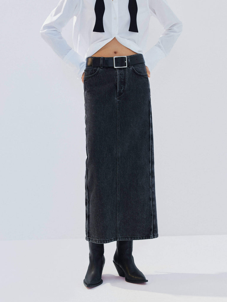 MO&Co. Noir Women's Straight Cut Denim Maxi Skirt Black Washed. Crafted from pure cotton, this skirt offers both comfort and style with its mid-length silhouette and side-washed fade effect.