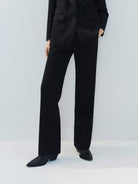 MO&Co. Noir Women's Tailored Straight Black Wool Suit Pants. The straight legs, full length design, hook-and-bar closure, and slanted pockets add to the tailored appeal of these versatile pants.