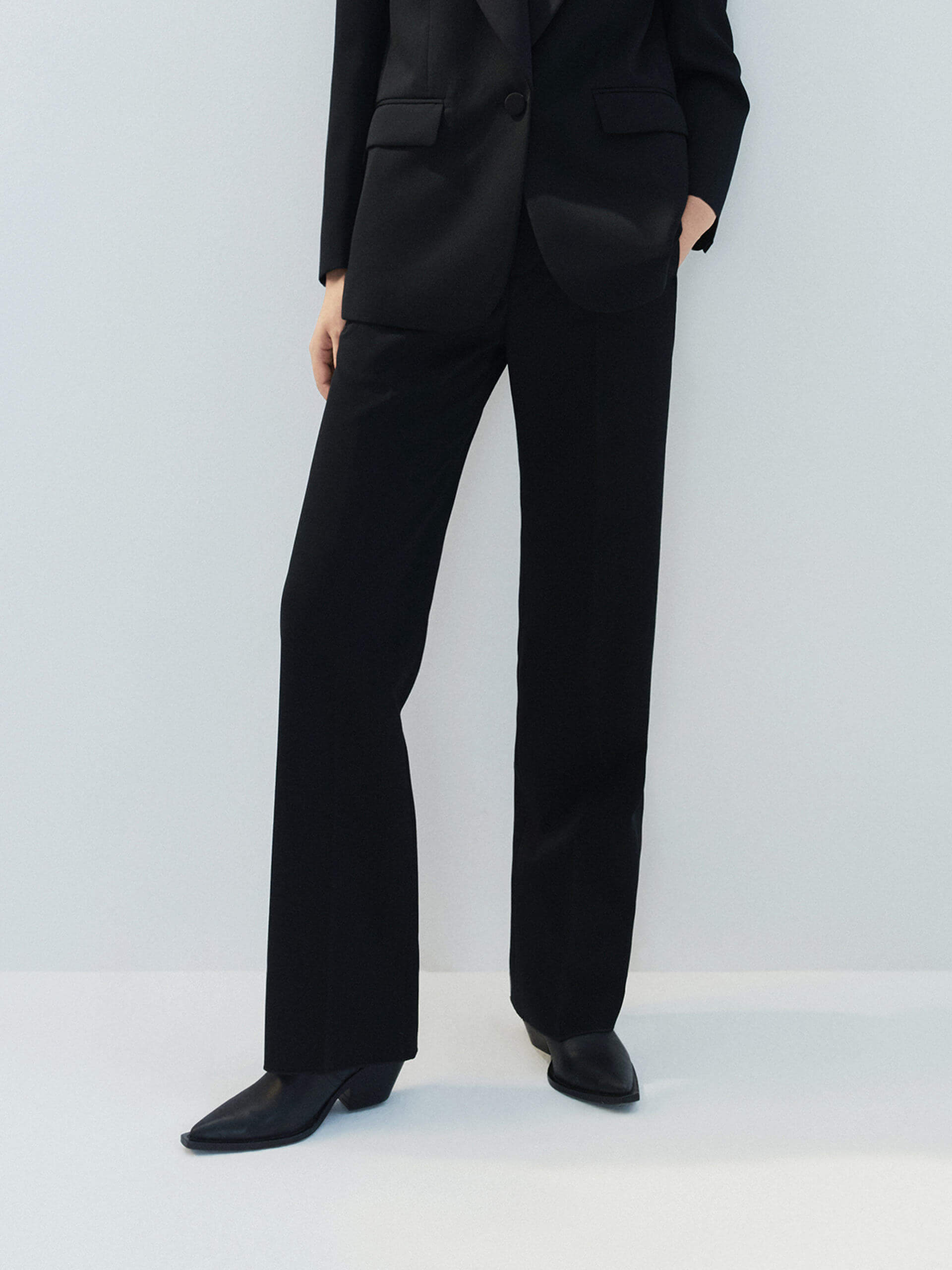 MO&Co. Noir Women's Tailored Straight Black Wool Suit Pants. The straight legs, full length design, hook-and-bar closure, and slanted pockets add to the tailored appeal of these versatile pants.