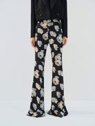 MO&Co. Noir Women's Floral Printed Full Length Flared Pants with a high waist, flared leg, comfy stretchy material, slanted pockets, and hook-and-bar closure, these pants offer both style and functionality.