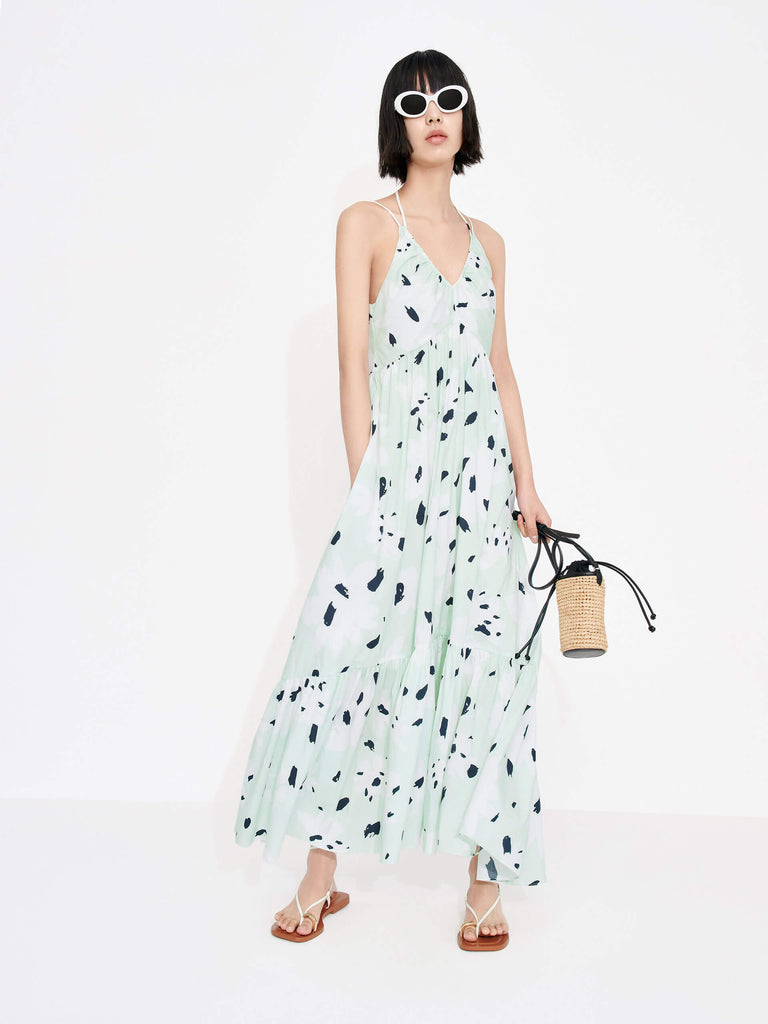 MO&Co. Women's Tropical Floral Print Vacation Maxi Dress in Mint features a V-neck, pleated details, cascading skirt and halterneck tie.