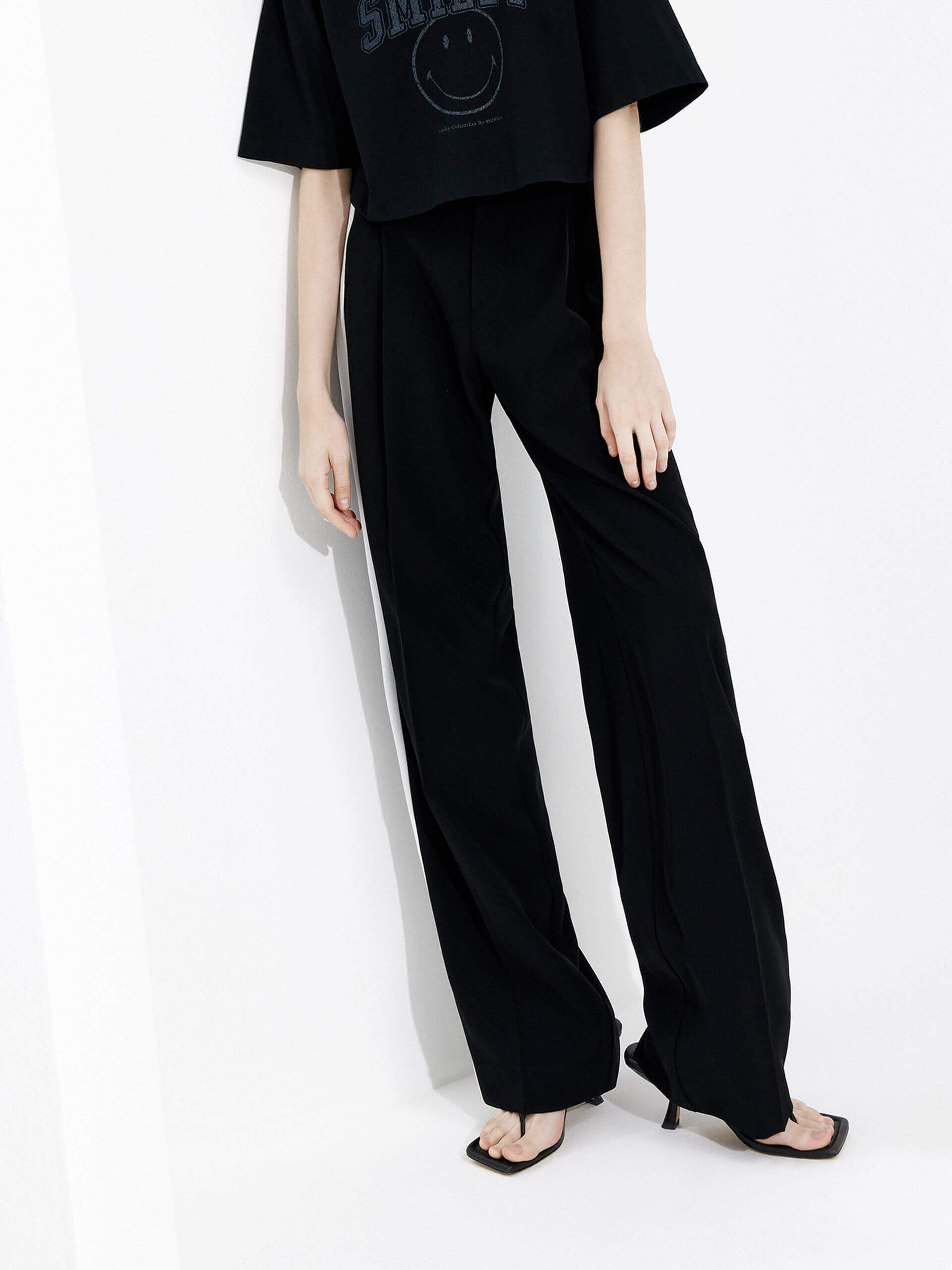 MO&Co. Women's Contrast Trim Straight Pants in Black: a fashionable look with white contrast trim design, wide and straight leg and side pockets, and belt loops and a zipper and hook closure.