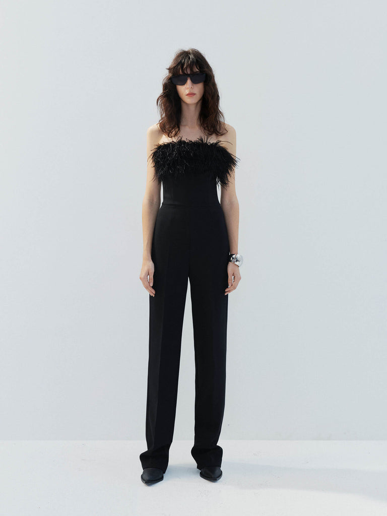 MO&Co. Noir Women's Feather Detail Fitted Jumpsuit Black features feather embellishments and a sleek straight-leg, strapless silhouette with a flattering fitted waist, ideal for a night out.