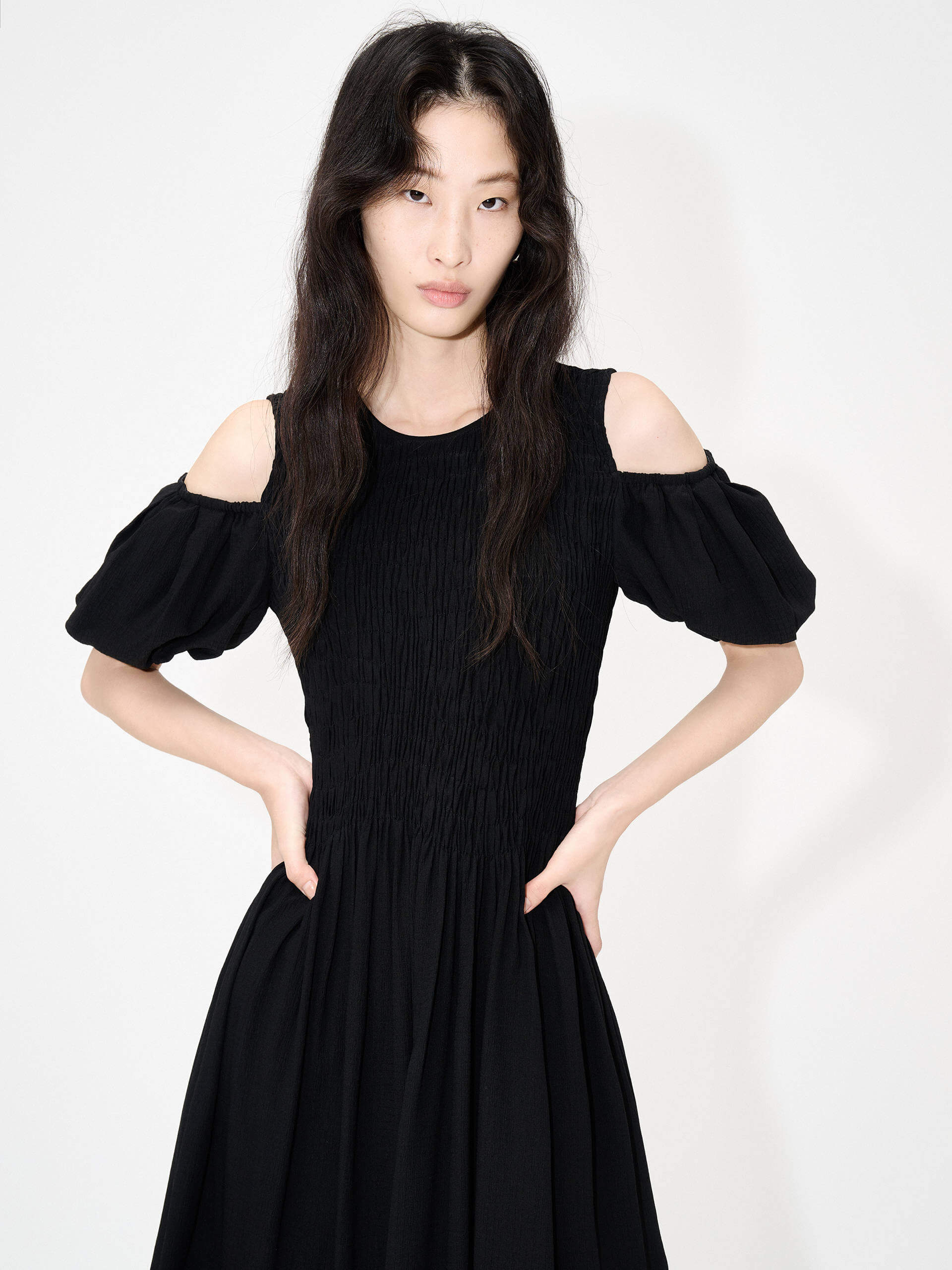 MO&Co. Women's Cut Shoulder Smocked Dress in Black. It features smocked detailing and shoulder cutouts for a flattering look with a unique, modern feel. Plus crafted from a blend of silk and polyester for an ultra-comfortable fit.