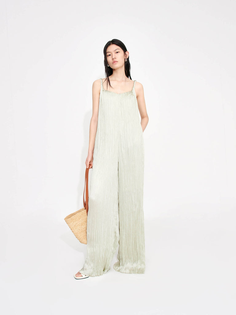 MO&Co. Women's Textured Wide Leg Jumpsuit in Mint features an included belt & double side pocket design. Its elegantly draped & twisted shoulder strap completes the look for a timeless classic.