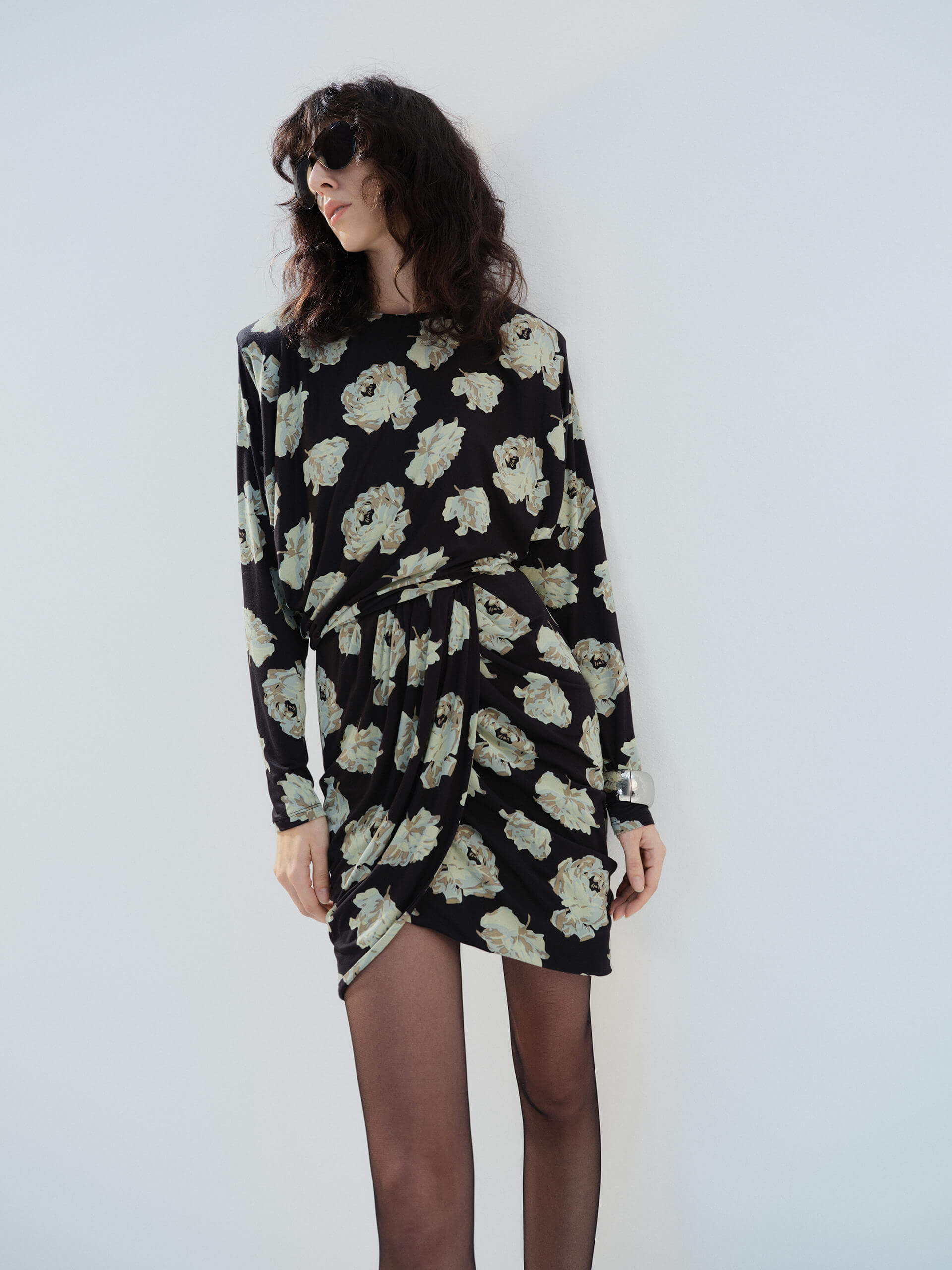 MO&Co. Noir Women's Floral Printed Long Sleeves Retro Mini Dress with padded shoulders, and a draped, ruched front.