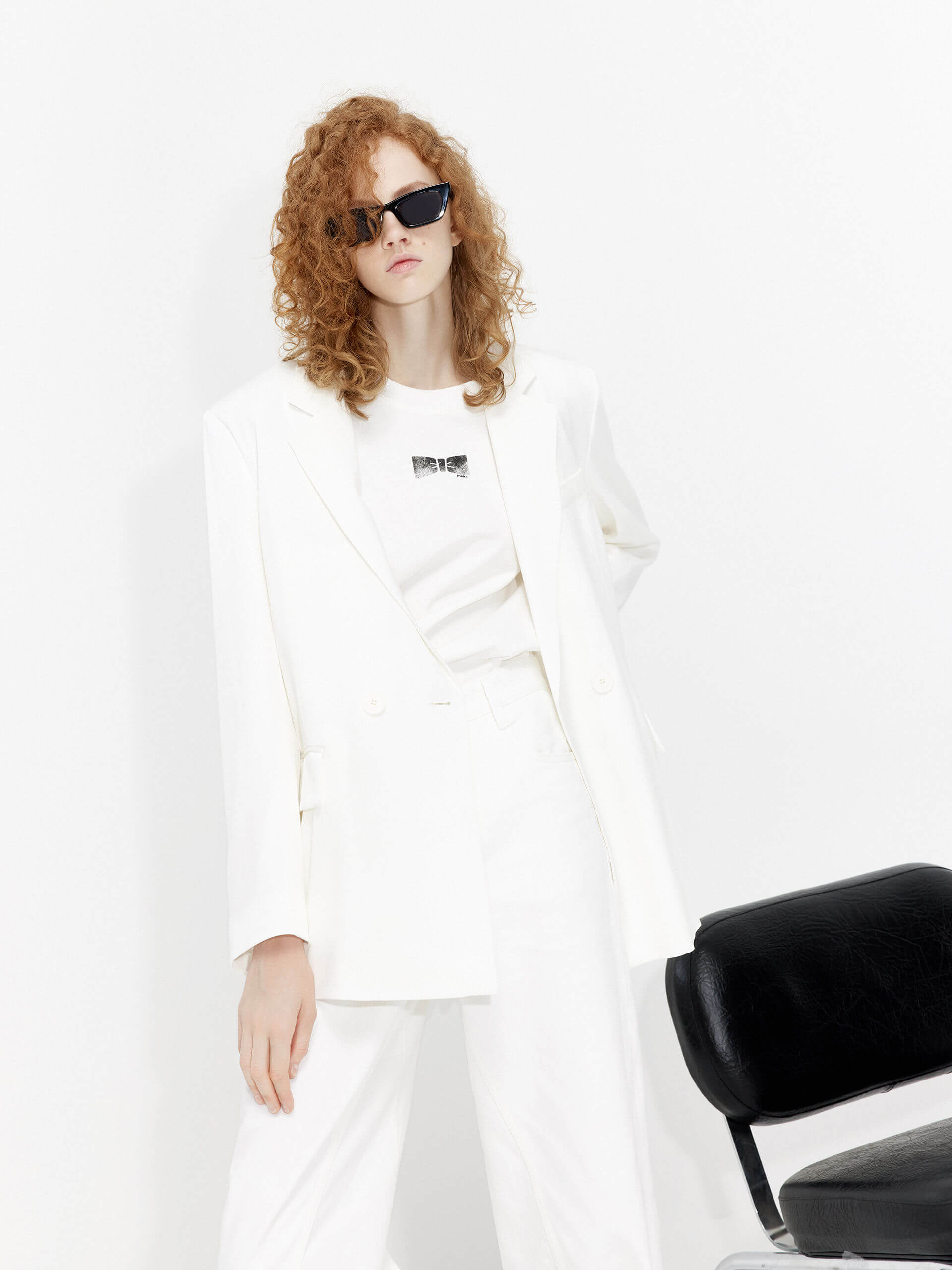 MO&Co. Bowknot Details Structured Blazer in White. Made from comfy, smooth acetate blend materials with intricate bowknot and slit details on the back, this blazer also includes shoulder pads and a button closure.