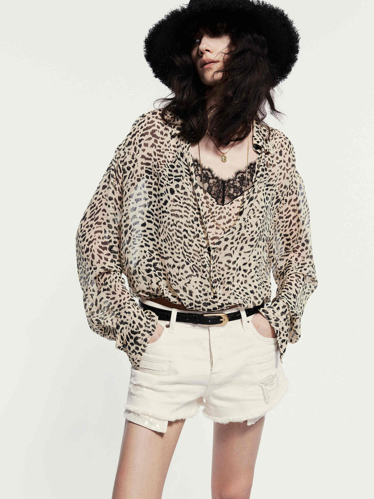 MO&Co. Noir Women's Leopard Print Silk Blouse. Crafted from smooth silk with a sheer effect, this blouse offers a flowy and relaxed fit that exudes feminine charm. The bold leopard print, V-neckline, and spliced lace detail add sophistication and visual interest to your look.
