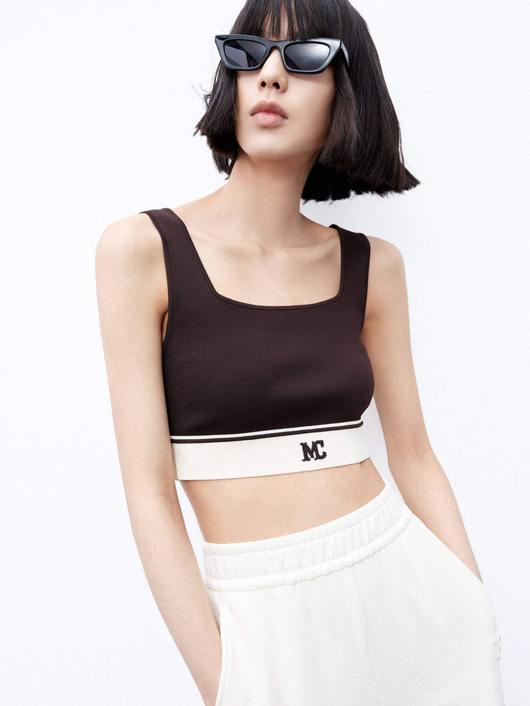 MO&Co. Women's Cropped Tank Top with Stretchy in Brown. Featuring a 50.9% viscose blend with a hint of stretch, squared neckline, a chic cropped silhouette & contrast palette with an "MC" logo.