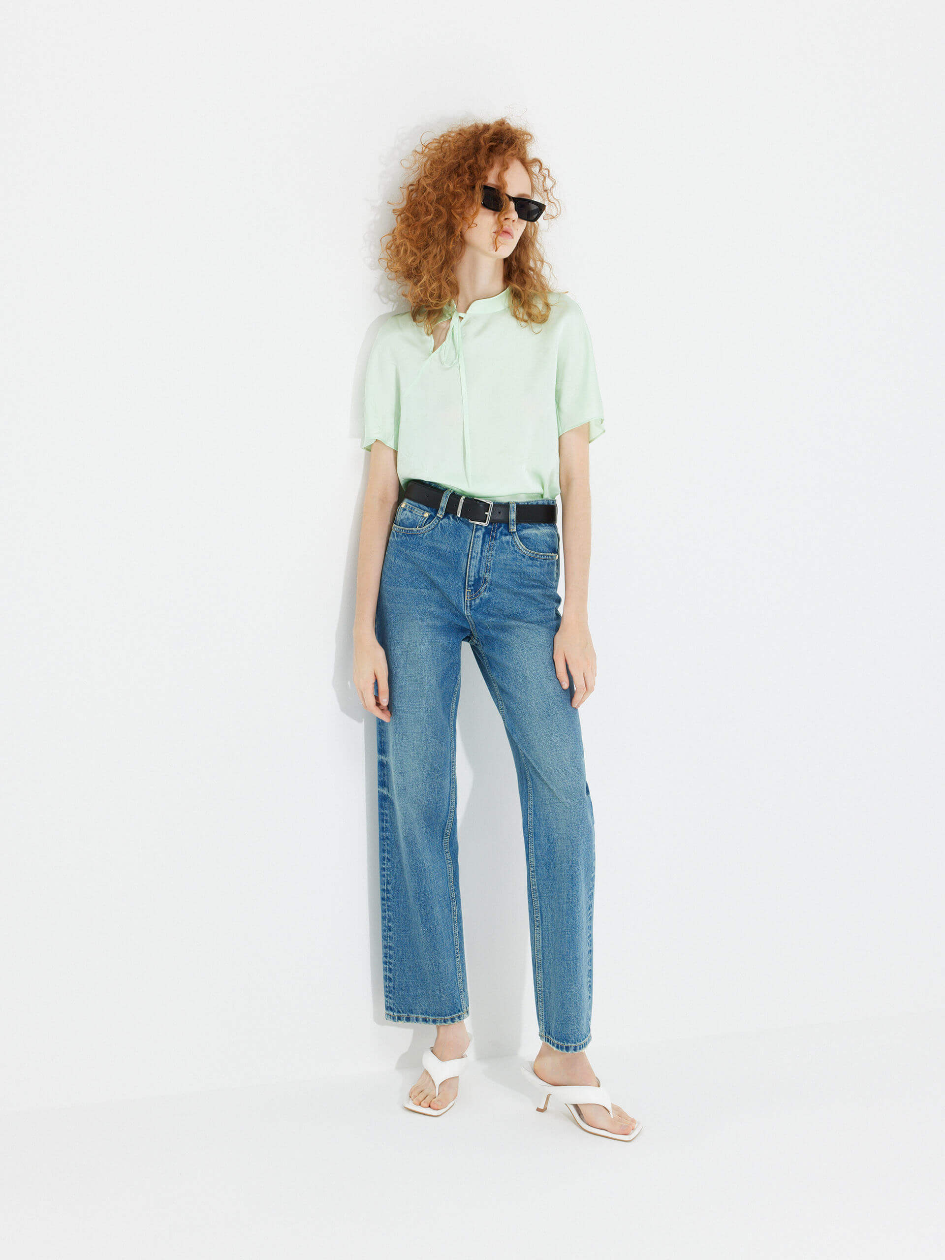 MO&Co. Women's Mid Waist Straight Whiskered Jeans in Blue features a secure button and zip closure, roomy five-pocket design, and easy accessorizing via the belt loops.