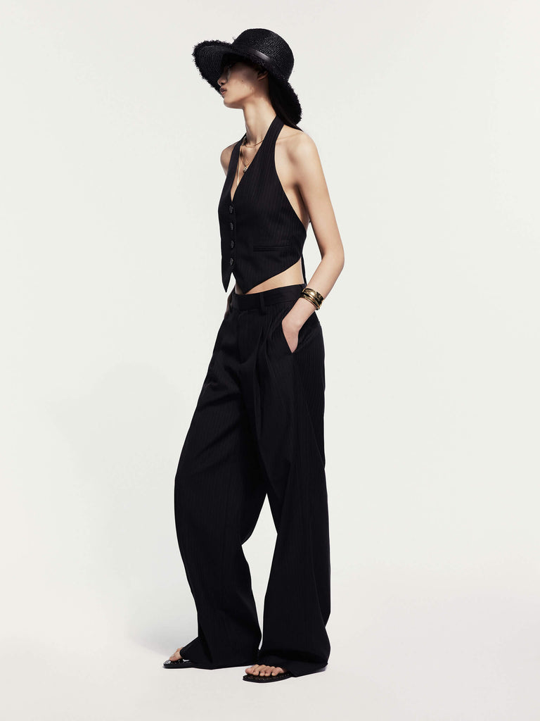 MO&Co. Noir Women's Fine Striped Wide Leg Wool Blend Pants in Black. Crafted from a luxurious wool blend, these wide-leg trousers offer both style and comfort for the cool season.