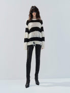 MO&Co. Noir Women's Distressed Detail Striped Oversized Pullover Crafted from a blend of mohair and wool, this sweater offers a fuzzy texture and distressed design for a modern twist. 