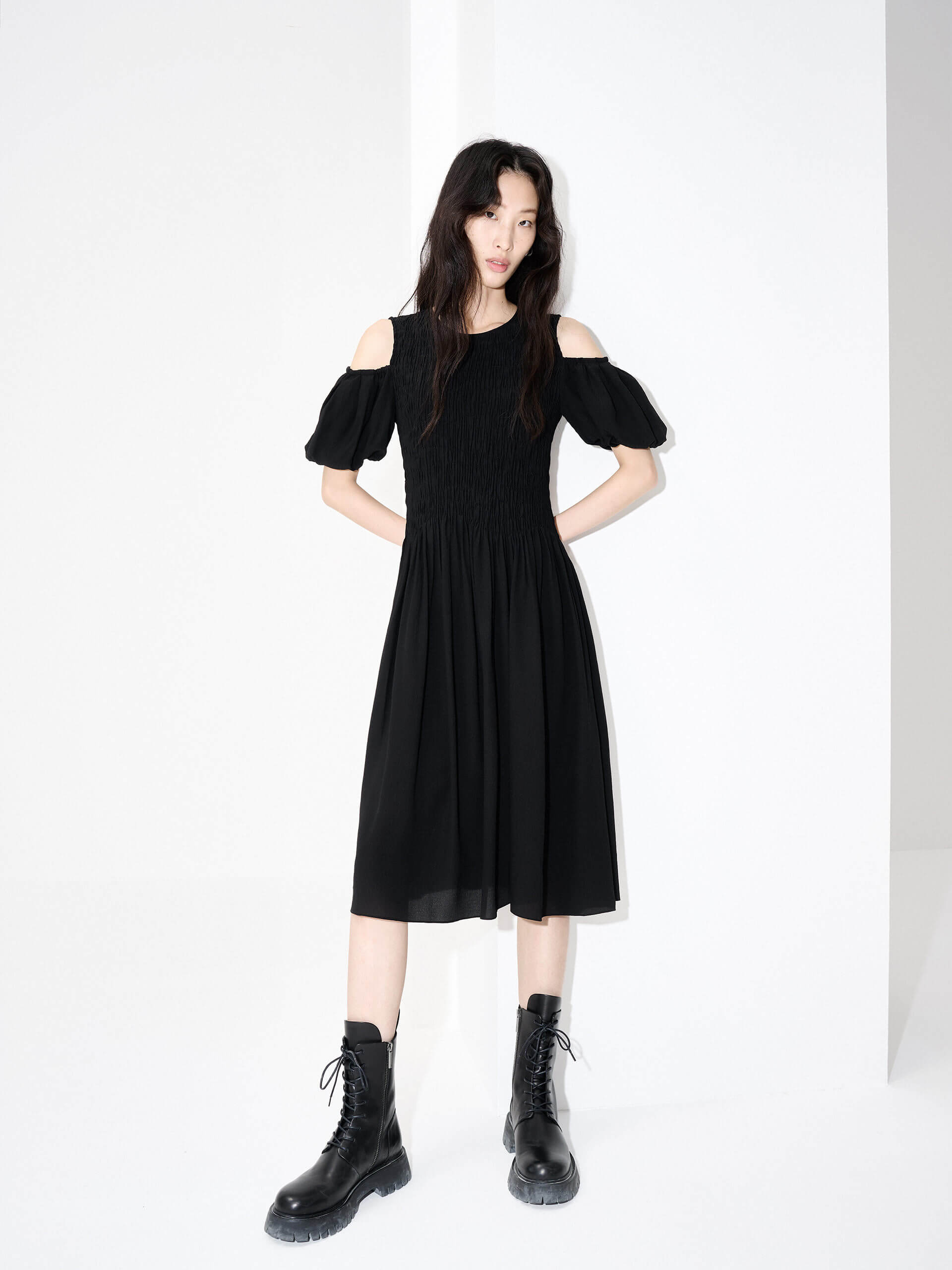 MO&Co. Women's Cut Shoulder Smocked Dress in Black. It features smocked detailing and shoulder cutouts for a flattering look with a unique, modern feel. Plus crafted from a blend of silk and polyester for an ultra-comfortable fit.