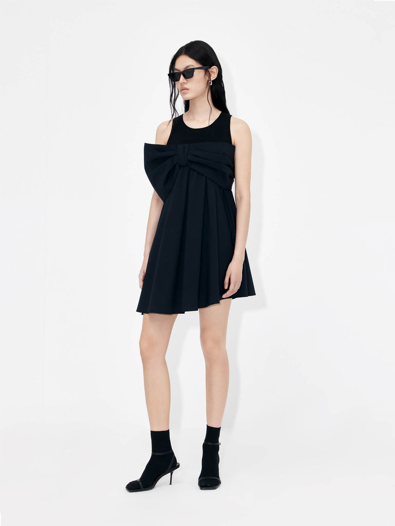 MO&Co. Bowknot Front Mini Dress in Black with sleeveless design. Crafted from a soft and breathable cotton blend, this feminine and sophisticated piece features an a-line silhouette with bowknot front details for an eye-catching look.